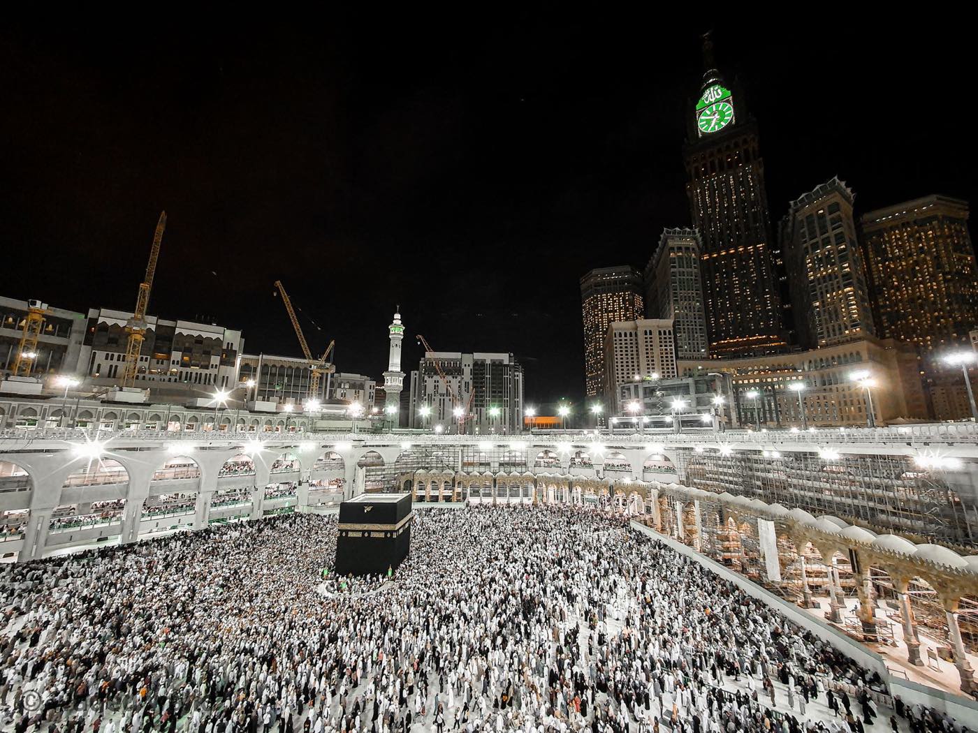 Masjid al-Haram and the Ka'bah in Makkah at night, surrounded by pilgrims